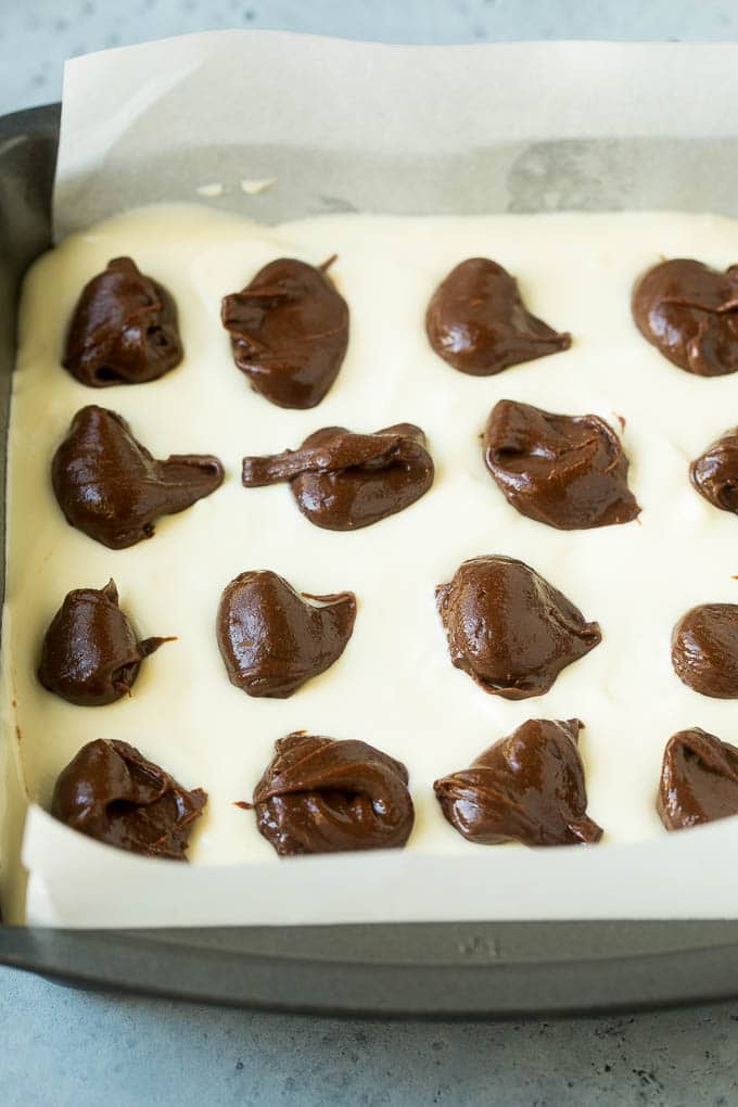 Cheesecake Brownies Recipe | Cream Cheese Brownies | Homemade Brownies #brownies #cheesecake #chocolate #dessert #fuyos Brownies topped with a layer of cheesecake and dollops of chocolate batter.