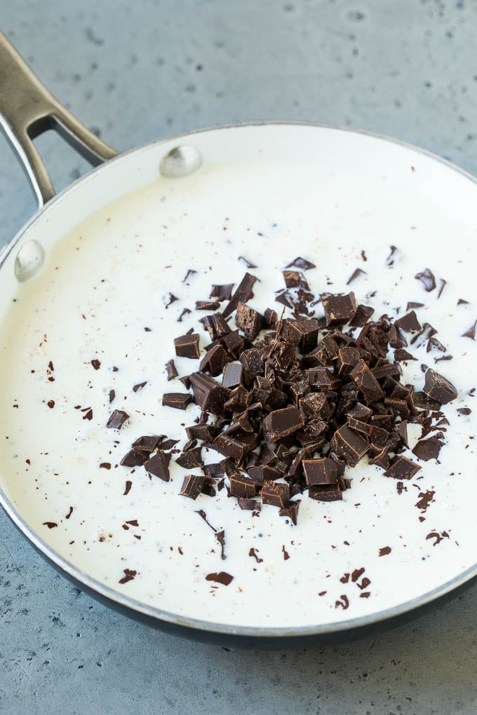 Chopped semi-sweet chunks and heavy cream in a skillet.