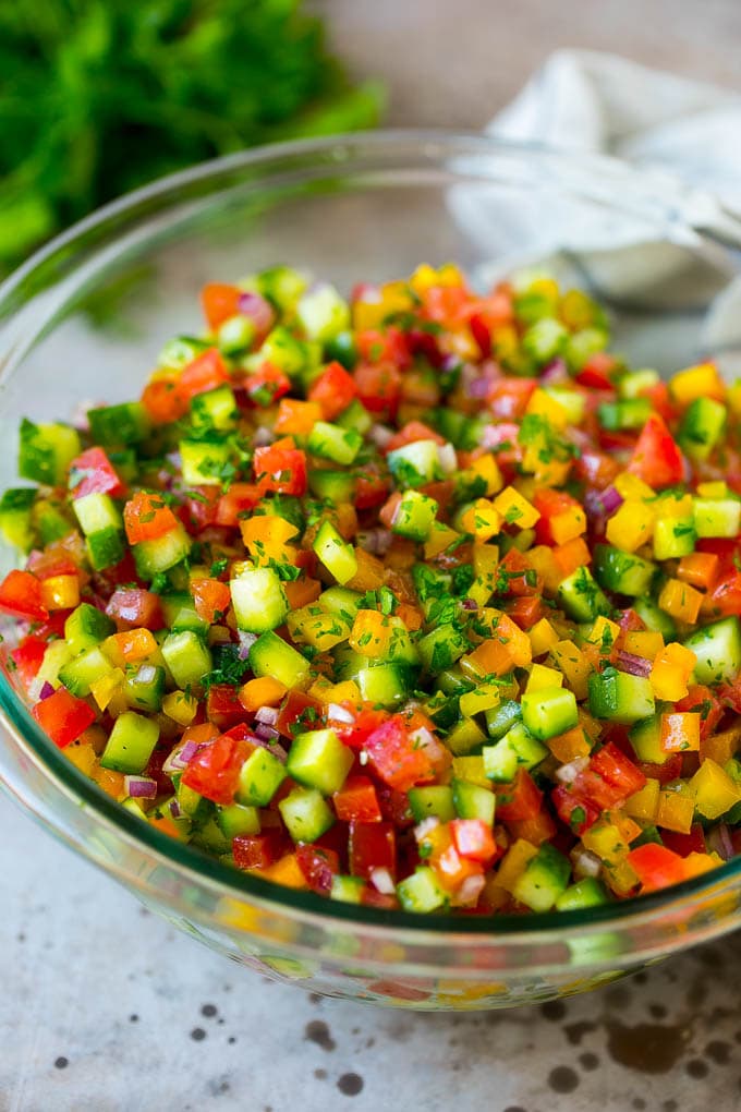 Israeli Salad Recipe | Cucumber Salad | Tomato Salad | Chopped Salad #salad #cleaneating #healthy #glutenfree #lowcarb #keto #sidedish #lunch #fuyos Israeli salad with cucumbers and tomatoes in a serving bowl.