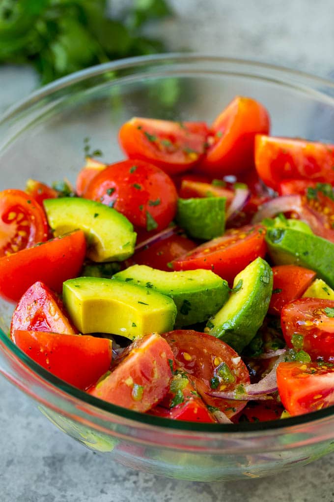 Avocado salad with tomatoes and red onion.