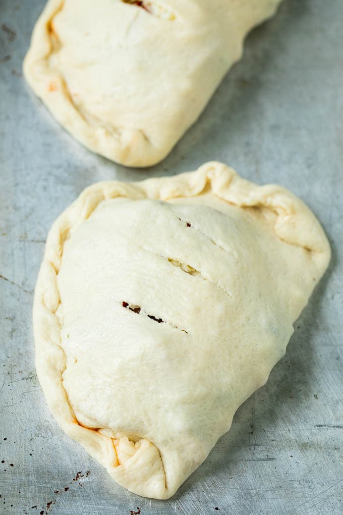 Calzone Recipe | Pizza Pockets #pizza #calzone #pepperoni #sausage #peppers #dinner #fuyos #cheese Unbaked calzones ready to go into the oven.