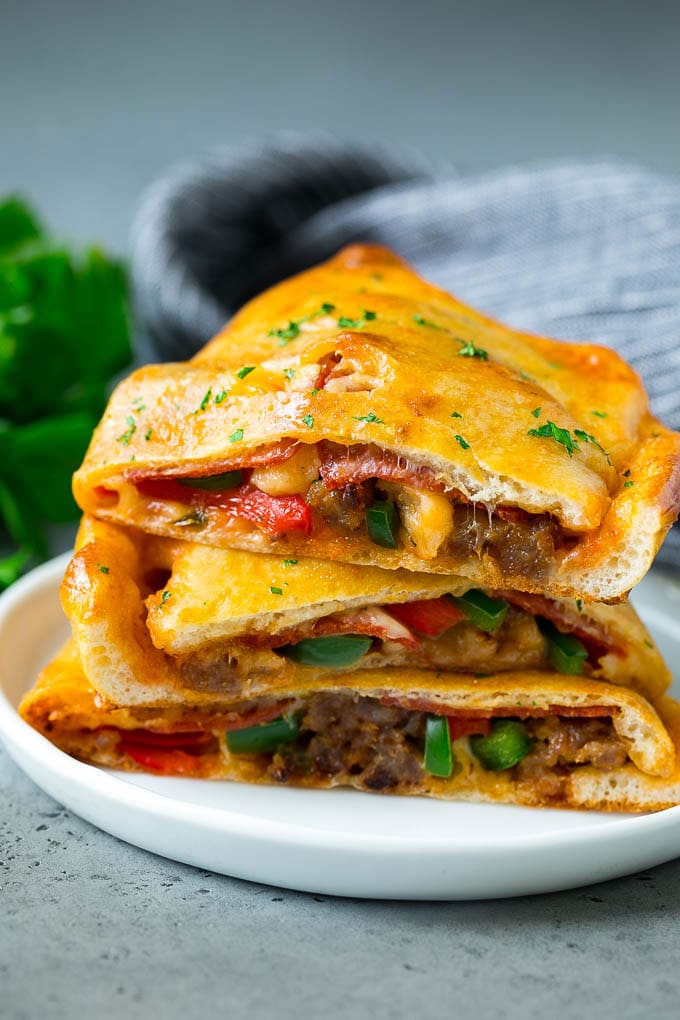 Calzone Recipe | Pizza Pockets #pizza #calzone #pepperoni #sausage #peppers #dinner #fuyos #cheese Calzone halves stuffed with sausage, peppers, cheese and pepperoni.