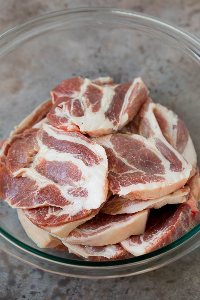 Tacos al Pastor Recipe | Pork Tacos | Mexican Tacos #tacos #pork #pineapple #grilling #tacotuesday #dinner #fuyos Sliced pork shoulder in a bowl.