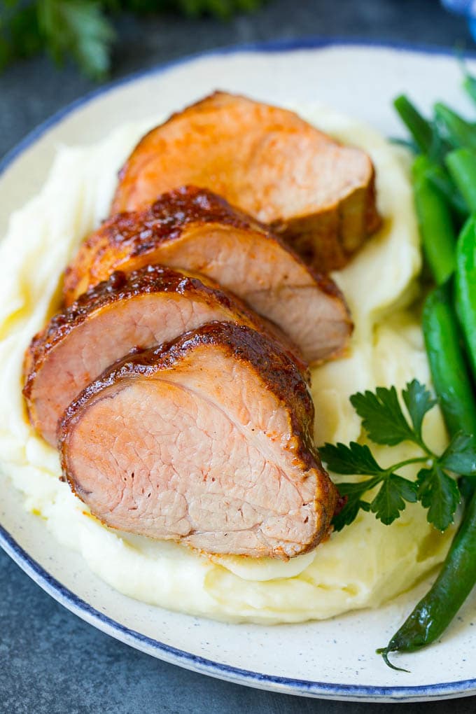 Smoked Pork Tenderloin Recipe | Smoked Pork Loin | BBQ Pork #pork #tenderloin #smoker #dinner #fuyos Sliced smoked pork tenderloin served with mashed potatoes and vegetables.