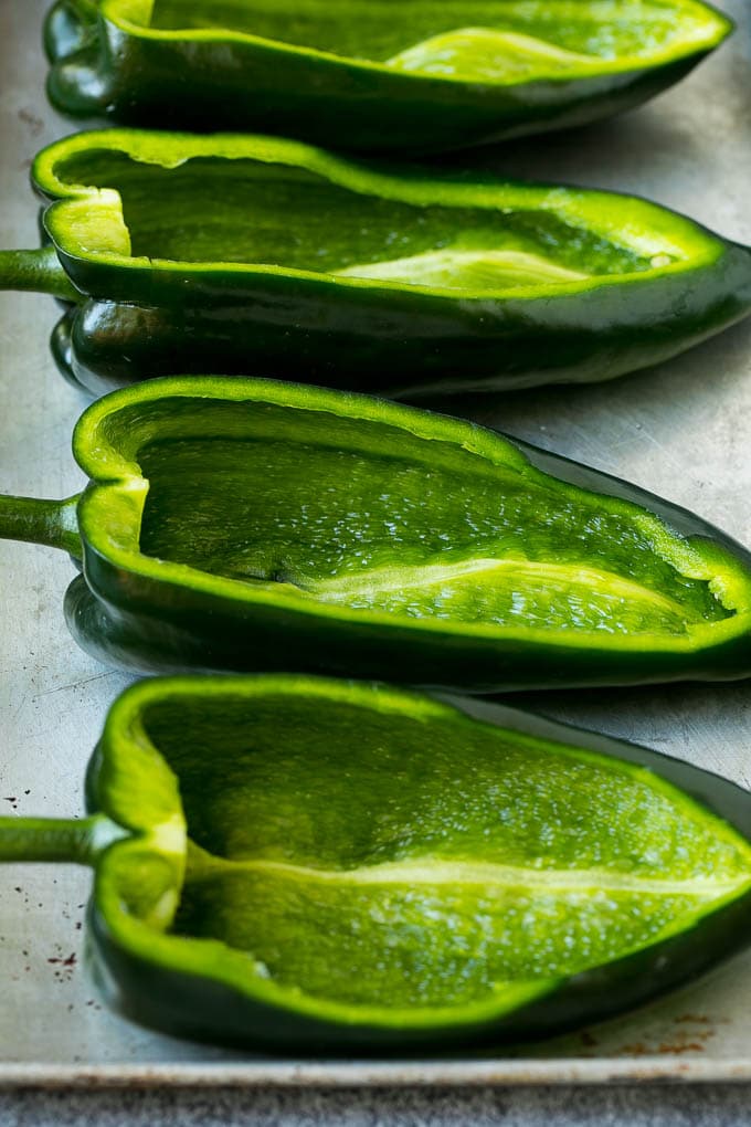 Stuffed Poblano Peppers | Stuffed Peppers | Pasilla Peppers #peppers #stuffedpeppers #beef #rice #beans #corn #dinner #fuyos Hollowed out poblano peppers on a pan.