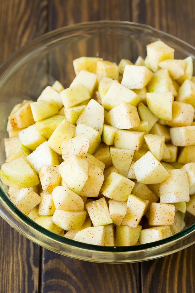 Apple Crisp Recipe | Apple Dessert #apples #dessert #baking #fall #fuyos Diced apples tossed with sugar and cinnamon in a bowl.