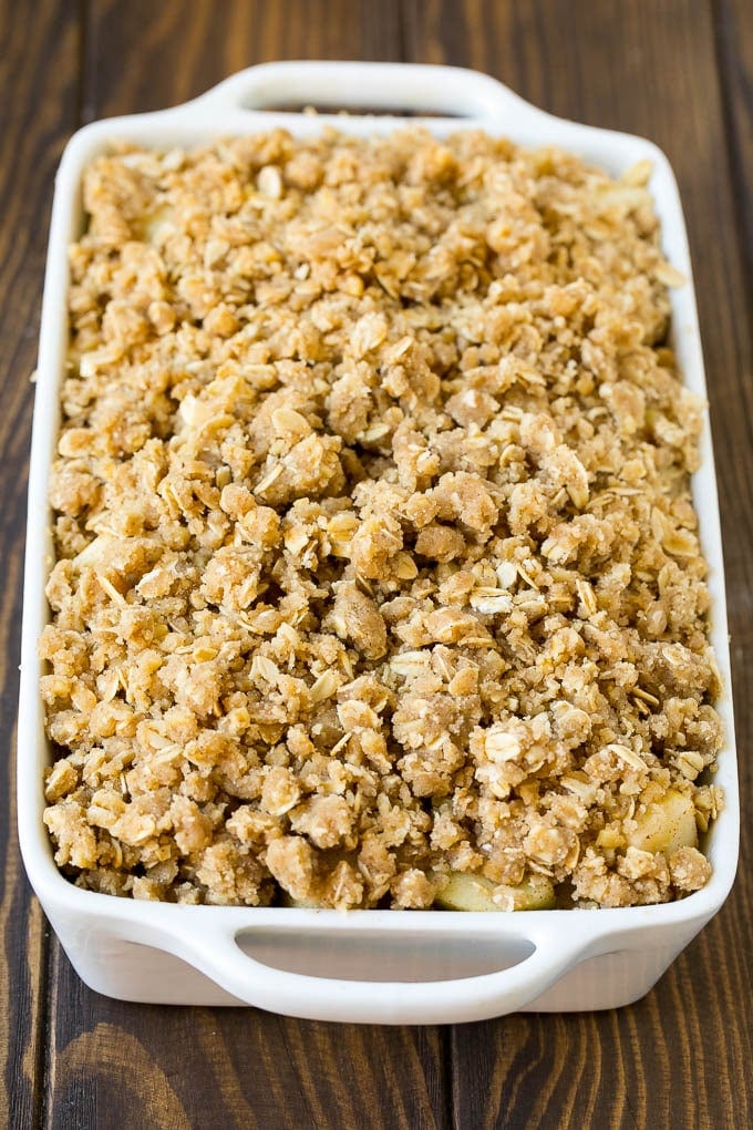 Apple Crisp Recipe | Apple Dessert #apples #dessert #baking #fall #fuyos Apples in a baking dish topped with brown sugar crumble.