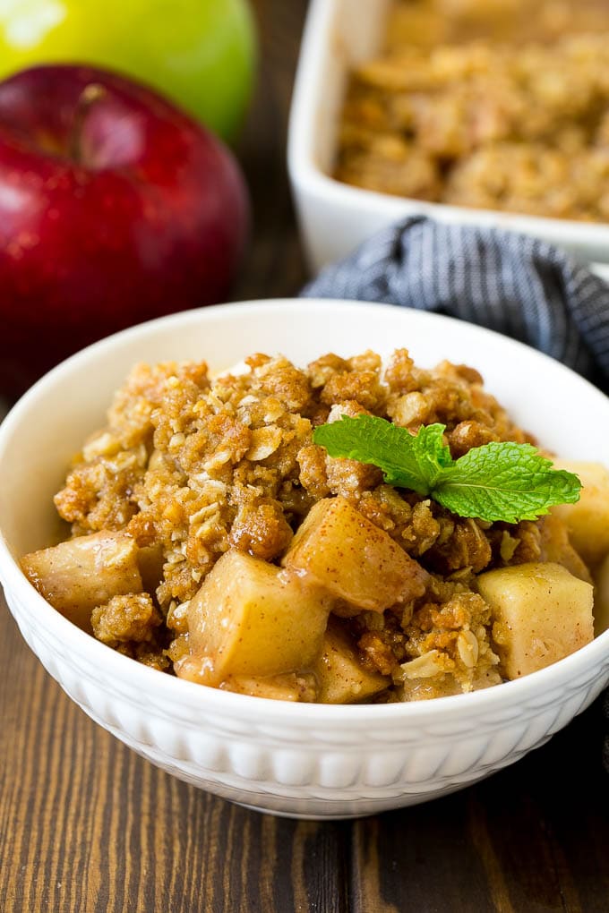 Apple Crisp Recipe | Apple Dessert #apples #dessert #baking #fall #fuyos A bowl of apple crisp garnished with a sprig of mint.