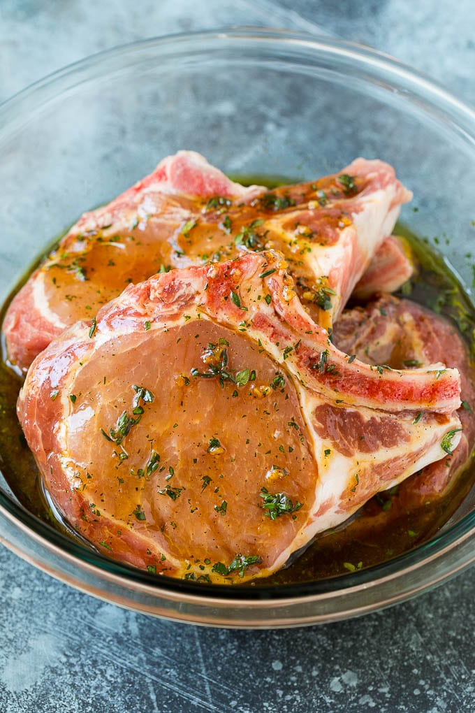Grilled Pork Chops | Pork Chop Marinade #porkchops #grilling #pork #marinade #dinner #fuyos Pork chops in a bowl of marinade.