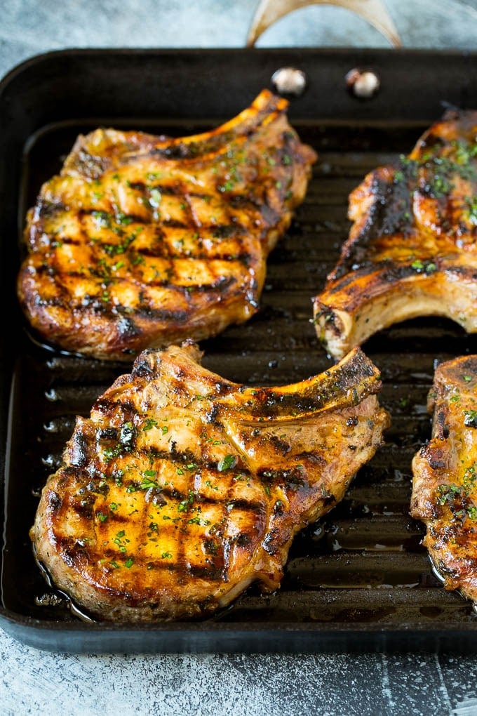 Grilled Pork Chops | Pork Chop Marinade #porkchops #grilling #pork #marinade #dinner #fuyos Pork chops on a grill pan.