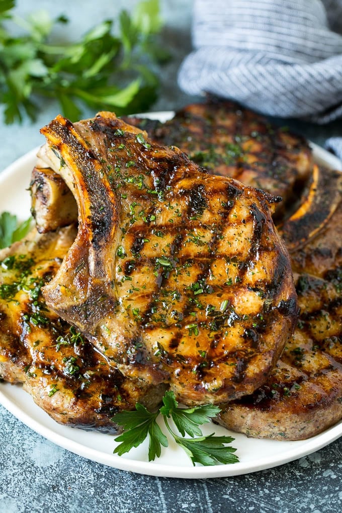 Grilled Pork Chops | Pork Chop Marinade #porkchops #grilling #pork #marinade #dinner #fuyos Grilled pork chops coated in marinade then cooked and garnished with parsley.