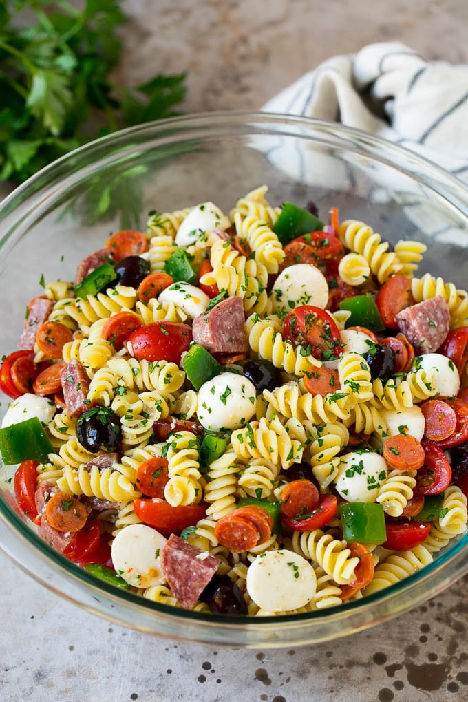 Italian Pasta Salad | Pasta Salad Recipe #pasta #salad #pastasalad #pepperoni #salami #olives #cheese #sidedish #fuyos A bowl of Italian pasta salad filled with meats, cheese and vegetables.
