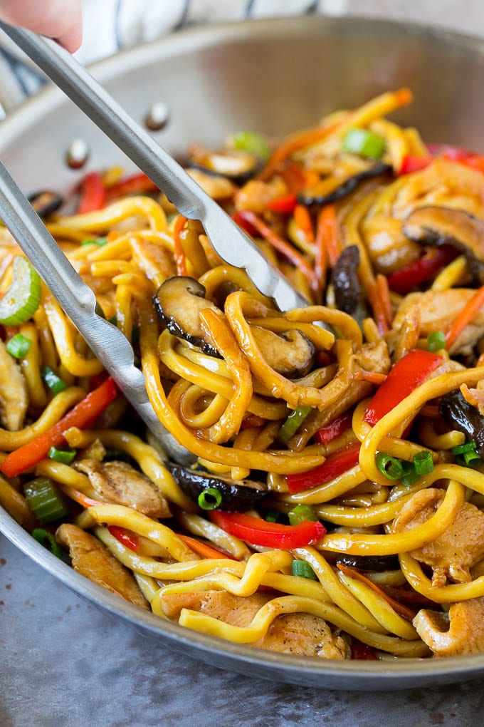 Stir Fry Noodles Recipe | Noodle Stir Fry #chicken #noodles #stirfry #mushrooms #dinner #fuyos Tongs serving up a portion of chicken and noodle stir fry.