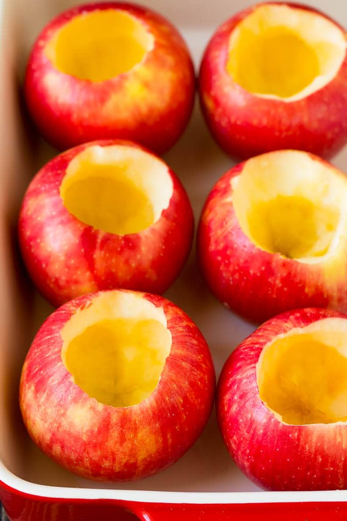 Baked Apples | Stuffed Apples #apples #fall #dessert #sweettooth #fuyos Hollowed out apples in a baking dish.