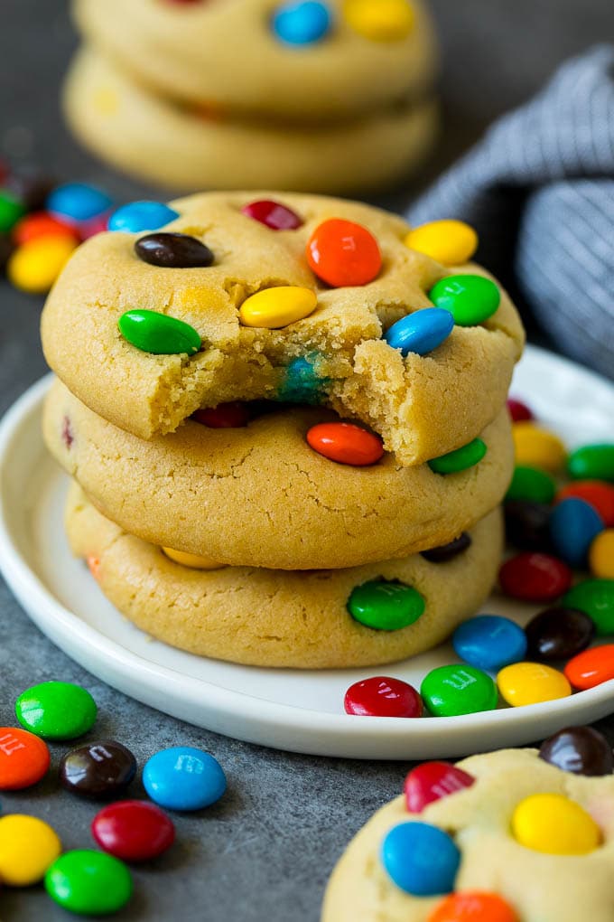 M&M Cookies Recipe #cookies #chocolate #baking #dessert #sweets #fuyos A stack of M&M cookies with a bite taken out of one.