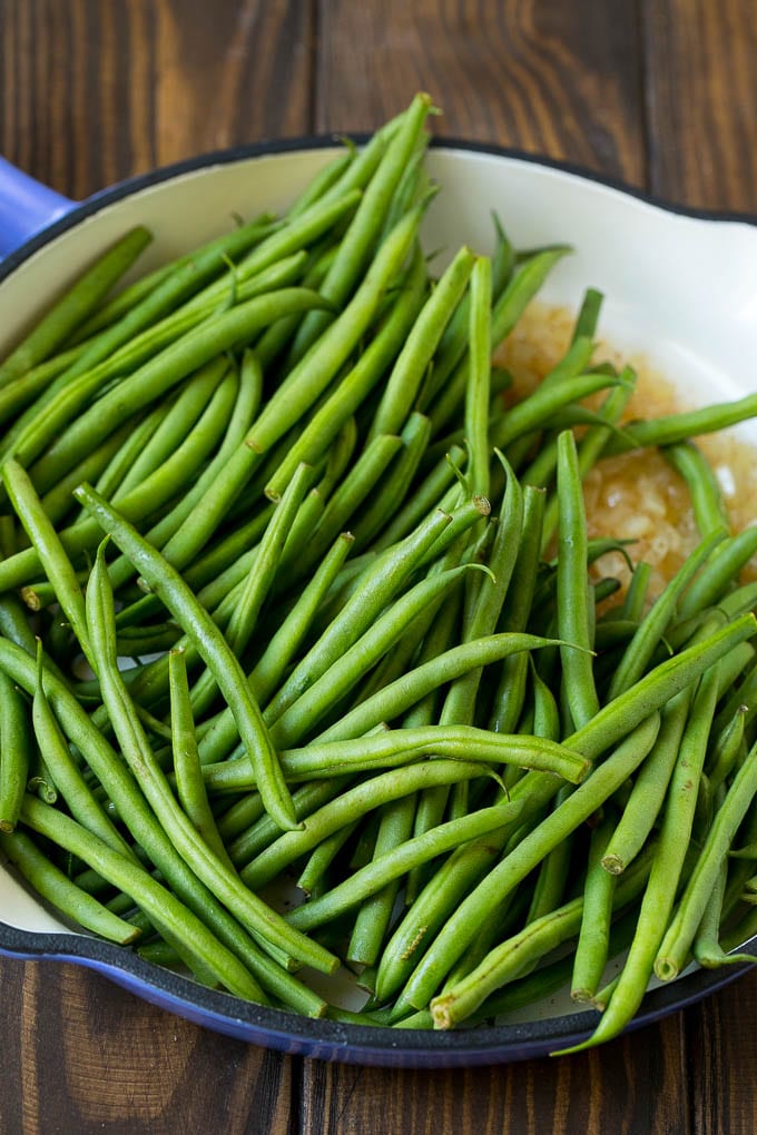 Green Beans with Bacon Recipe | Bacon Green Beans #bacon #greenbeans #sidedish #thanksgiving #veggies #dinner #fuyos Beans in a pan with onions.