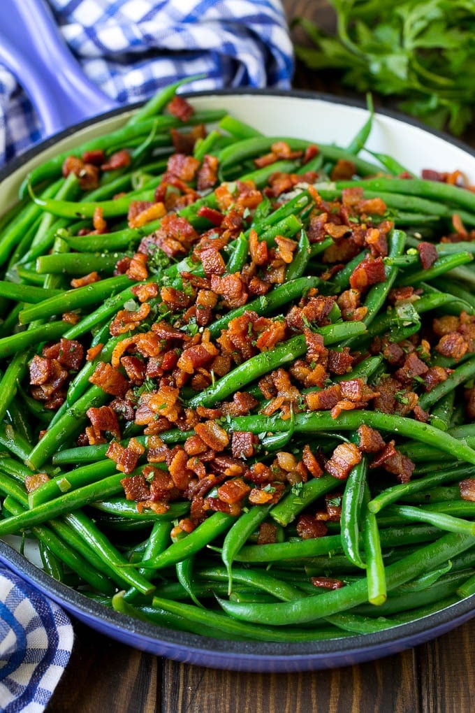 Green Beans with Bacon Recipe | Bacon Green Beans #bacon #greenbeans #sidedish #thanksgiving #veggies #dinner #fuyos Green beans with bacon in a skillet, topped with parsley.