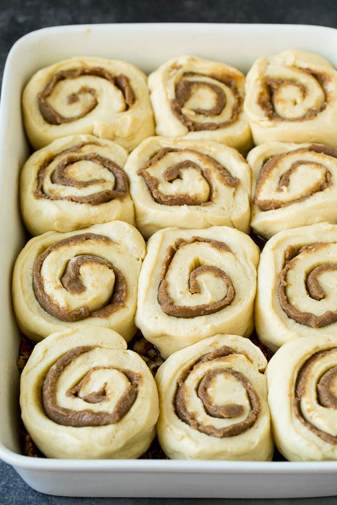 Sticky Buns Recipe | Sweet Rolls | Cinnamon Rolls #breakfast #brunch #cinnamon #pecans #fuyos #bread Cinnamon swirl dough in a baking dish.