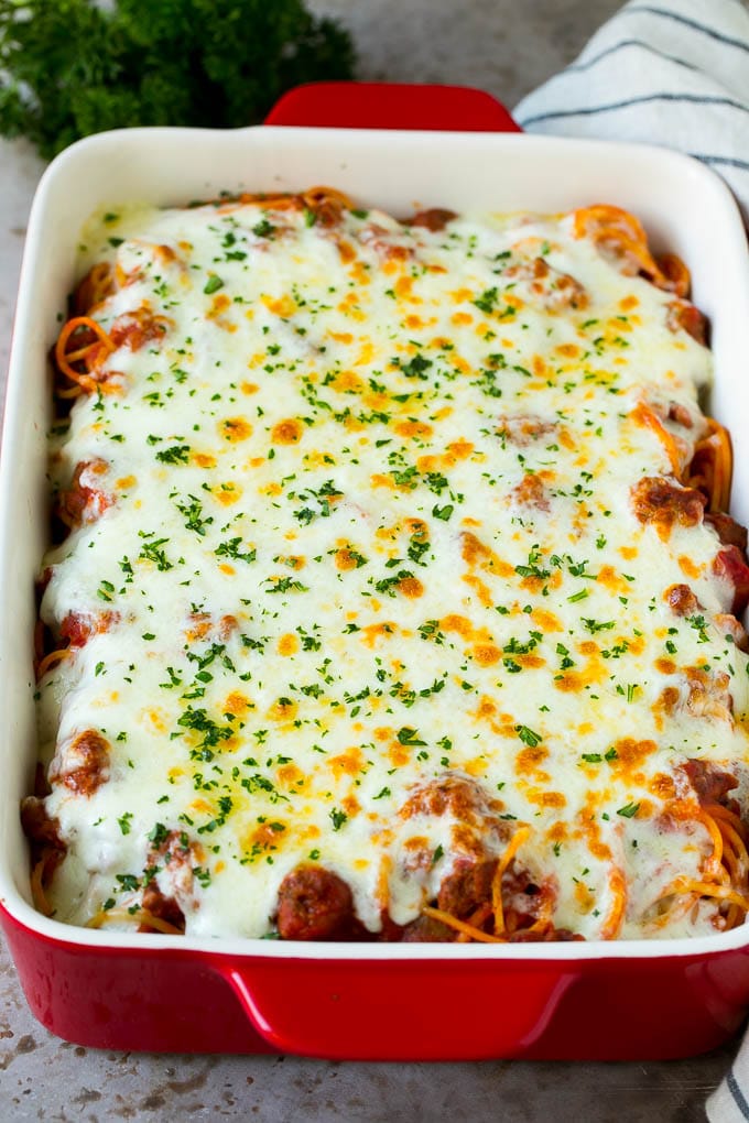 Baked Spaghetti Recipe | Baked Pasta #spaghetti #pasta #cheese #casserole #beef #sausage #dinner #fuyos Spaghetti in a baking dish with melted cheese baked on top.