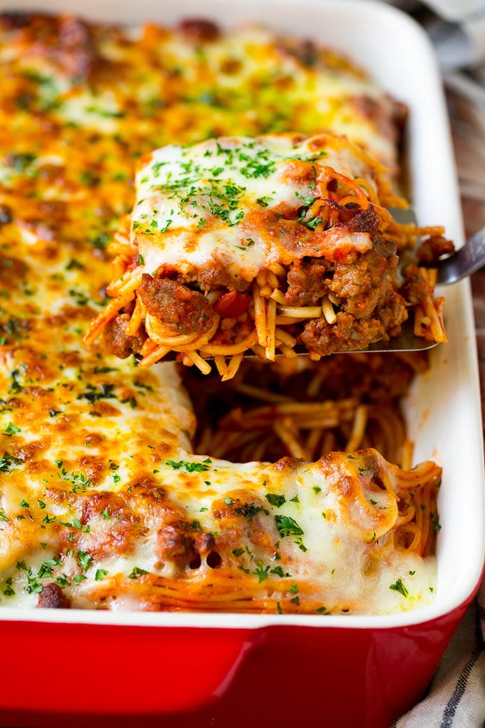 Baked Spaghetti Recipe | Baked Pasta #spaghetti #pasta #cheese #casserole #beef #sausage #dinner #fuyos A spatula holding up a serving of baked spaghetti.