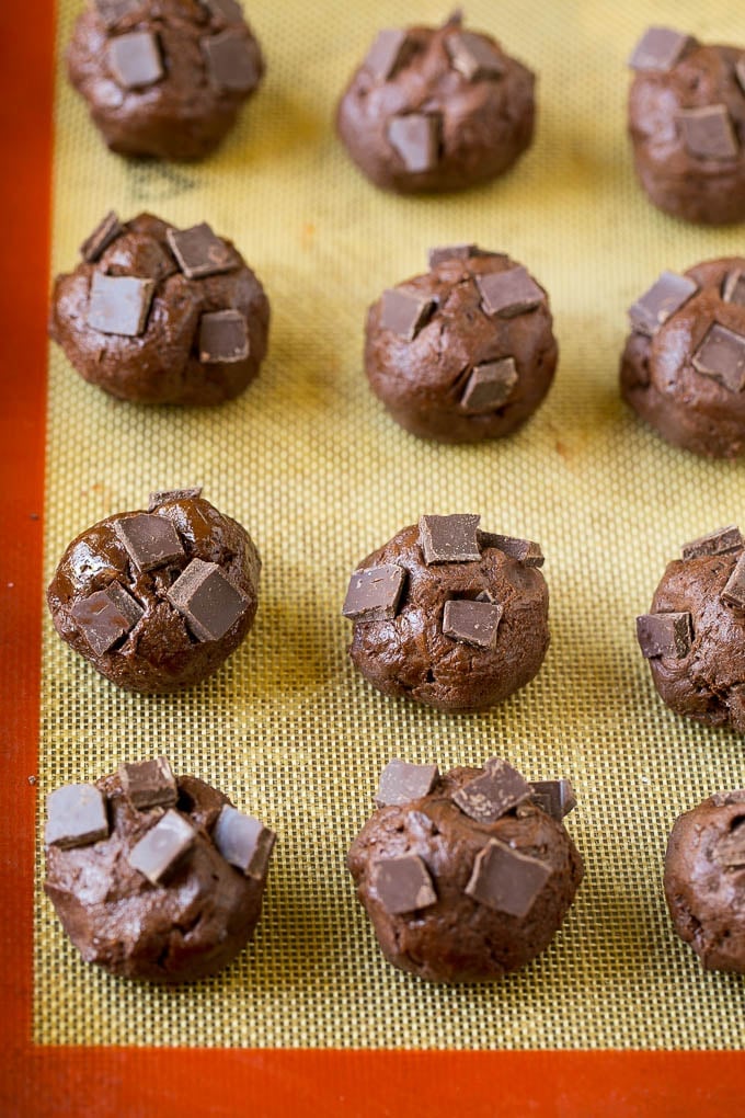 Brownie Cookies Recipe | Chocolate Cookies #cookies #brownies #chocolate #dessert #baking #fuyos Balls of cookie dough with chocolate pieces pressed into the tops.