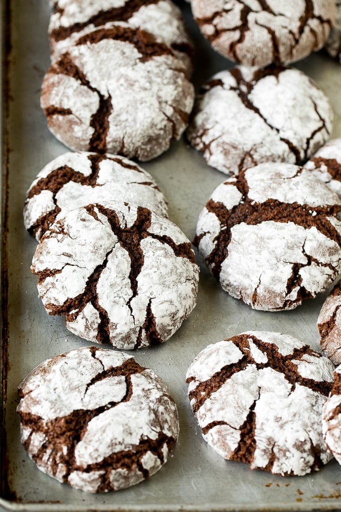 Chocolate Crinkle Cookies Recipe #cookies #chocolate #christmas #dessert #baking #fuyos Crinkle cookies on a sheet pan.