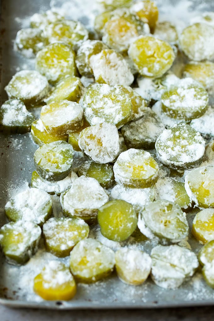 Fried Pickles Recipe #pickles #appetizer #snack #fuyos Pickle slices coated in flour.