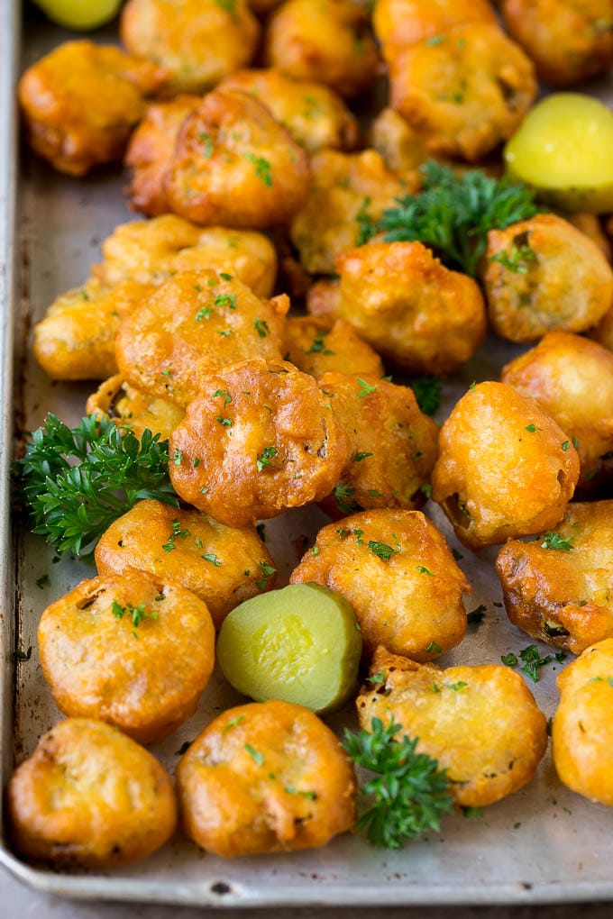 Fried Pickles Recipe #pickles #appetizer #snack #fuyos Fried pickles on a sheet pan, garnished with parsley.