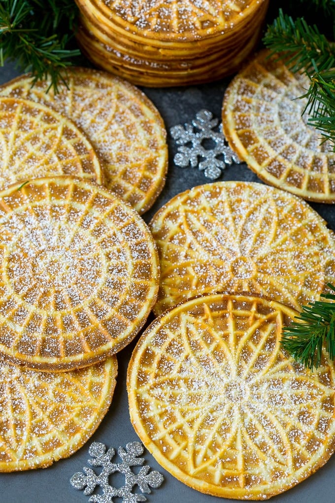 Pizzelle Cookies Recipe #cookies #baking #dessert #christmas #fuyos Pizzelle cookies cooked to golden brown and coated in powdered sugar.