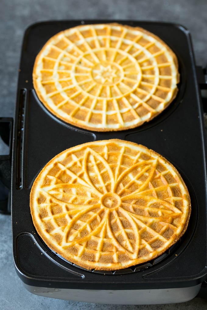 Pizzelle Cookies Recipe #cookies #baking #dessert #christmas #fuyos Baked cookies inside a pizzelle iron.