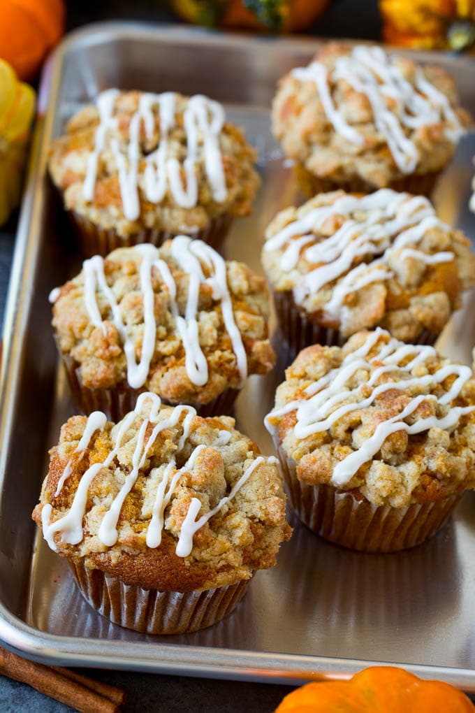 A tray of pumpkin muffins topped with glaze.
