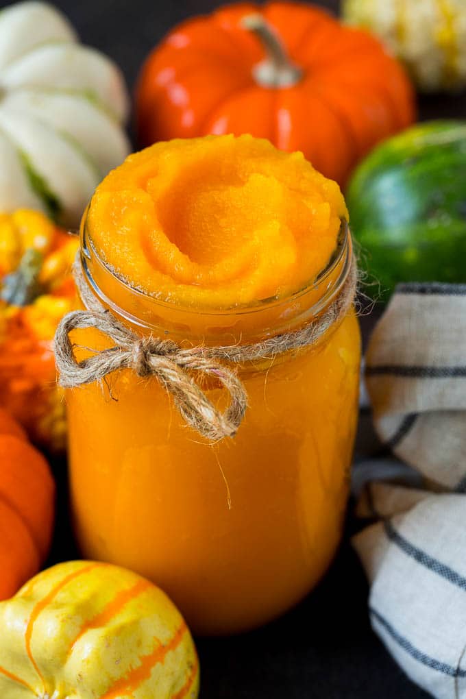 Pumpkin Puree Recipe #pumpkin #baking #fall #thanksgiving #fuyos A jar of pumpkin puree surrounded by fall produce.