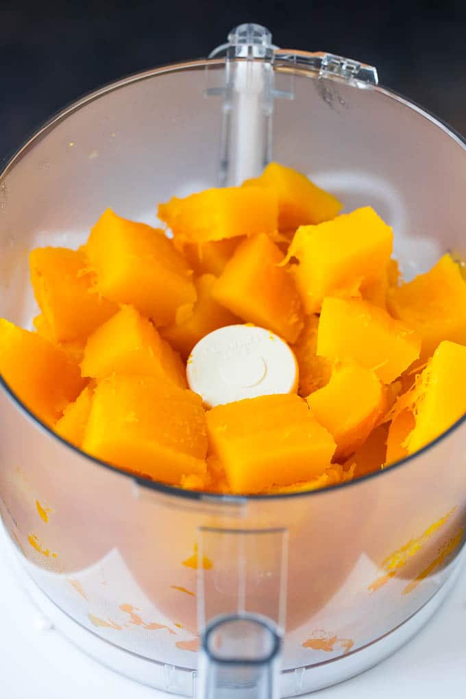 Pumpkin Puree Recipe #pumpkin #baking #fall #thanksgiving #fuyos Cubes of pumpkin in a food processor.