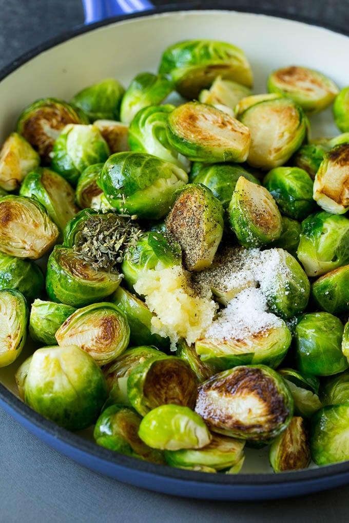 Sauteed Brussels Sprouts Recipe | Brussels Sprouts Side Dish #brusselssprouts #sprouts #veggies #sidedish #garlic #vegetarian #dinner #fuyos Sprouts in a pan seasoned with salt, pepper, garlic and dried herbs.