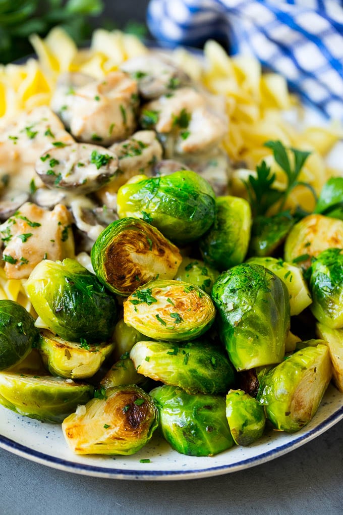Sauteed Brussels Sprouts Recipe | Brussels Sprouts Side Dish #brusselssprouts #sprouts #veggies #sidedish #garlic #vegetarian #dinner #fuyos Sauteed brussels sprouts served alongside chicken and noodles.