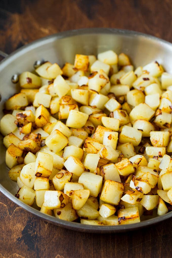 Corned Beef Hash Recipe #hash #cornedbeef #stpatricksday #breakfast #brunch #potatoes #fuyos Sauteed potatoes in a skillet.