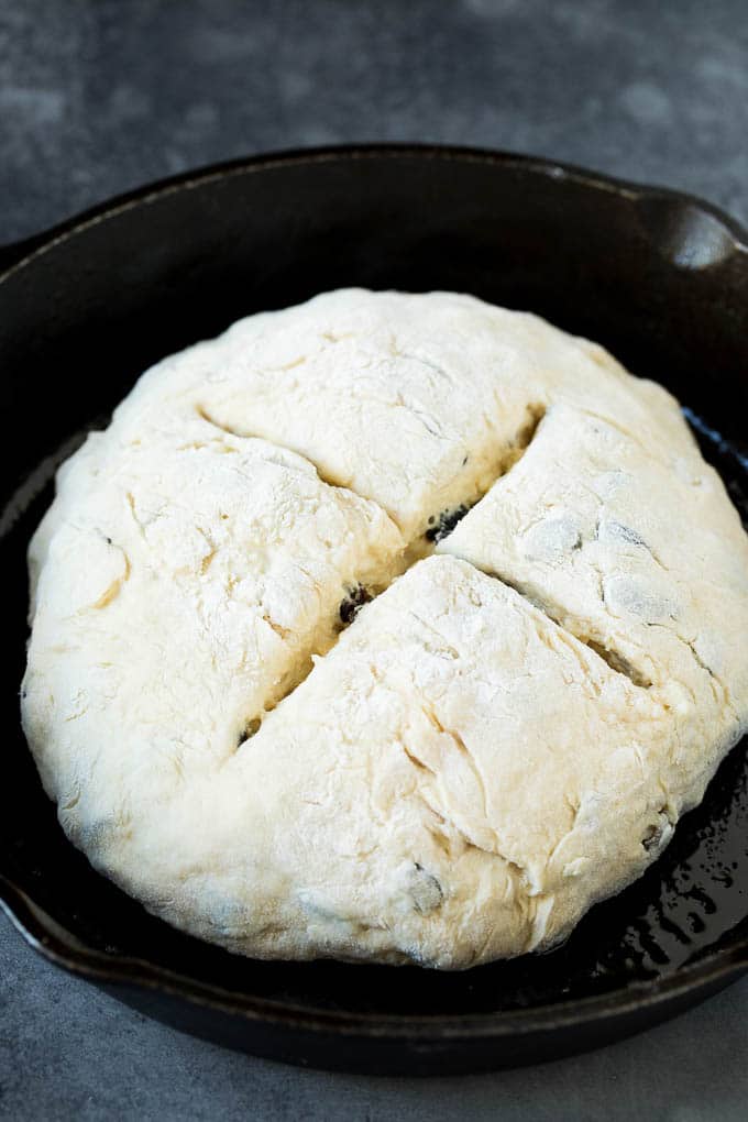 Irish Soda Bread Recipe #bread #baking #stpatricksday #sidedish #fuyos A shaped loaf of soda bread in a skillet.
