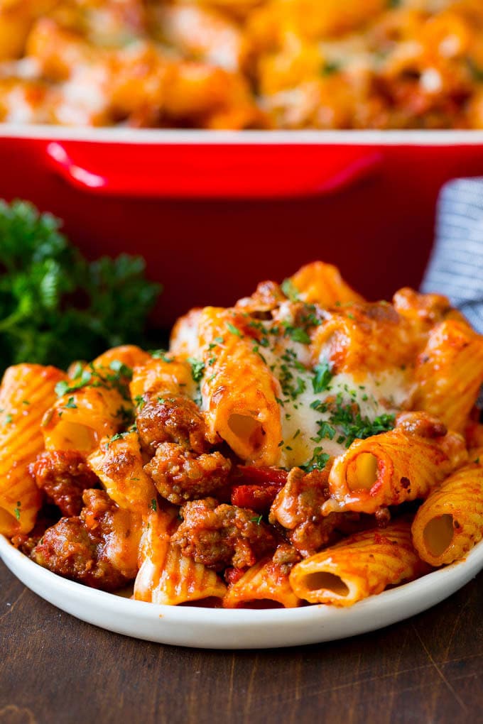Baked Rigatoni Pasta #pasta #dinner #italianfood #groundbeef #fuyos #casserole A plate of baked rigatoni topped with melted cheese.