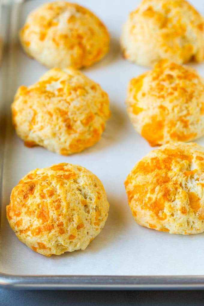 Baked biscuits on a sheet pan.
