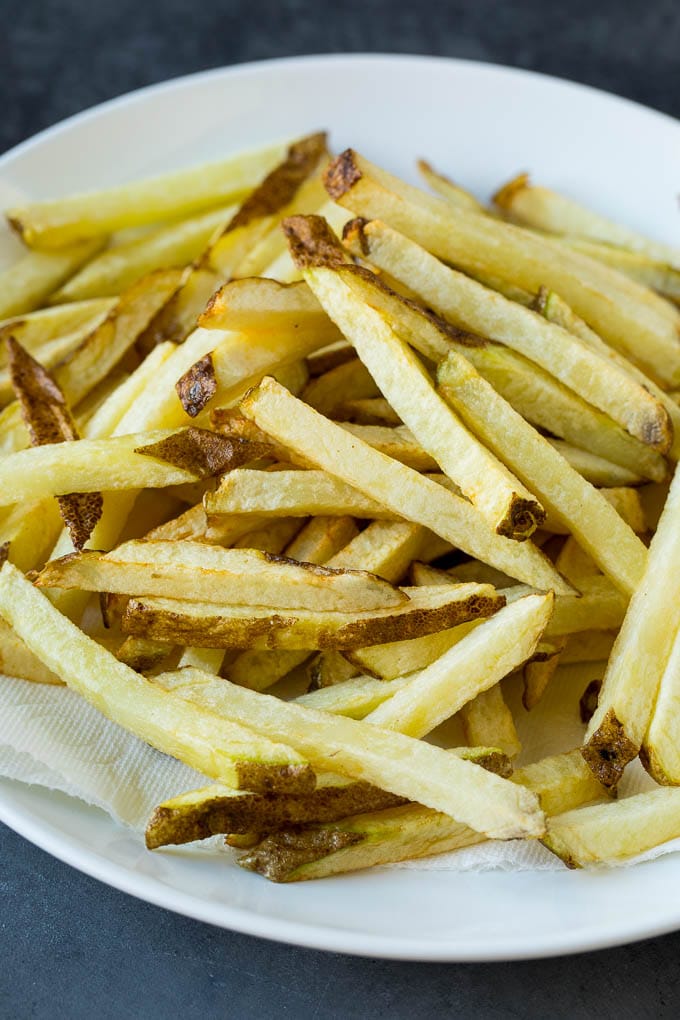 Homemade French Fries Recipe #potatoes #fries #dinner #fuyos Par-fried potatoes on a plate.