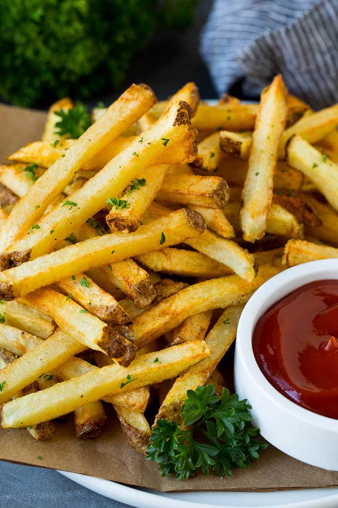 Homemade French Fries Recipe #potatoes #fries #dinner #fuyos A plate of homemade french fries served with a bowl of ketchup.