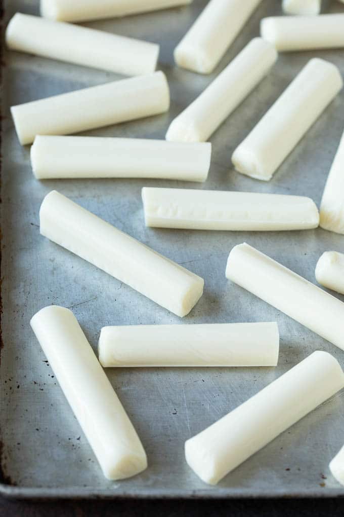 Mozzarella Sticks Recipe #cheese #appetizer #fuyos Cheese sticks on a sheet pan.
