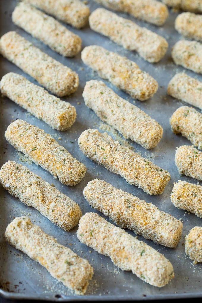 Mozzarella Sticks Recipe #cheese #appetizer #fuyos Breaded cheese on a baking pan.