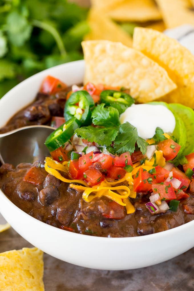A spoon in a bowl of black bean soup.
