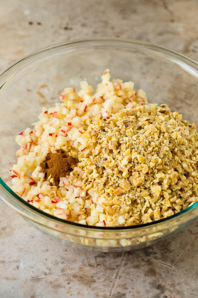 Apples, wine, cinnamon and honey all in a bowl.