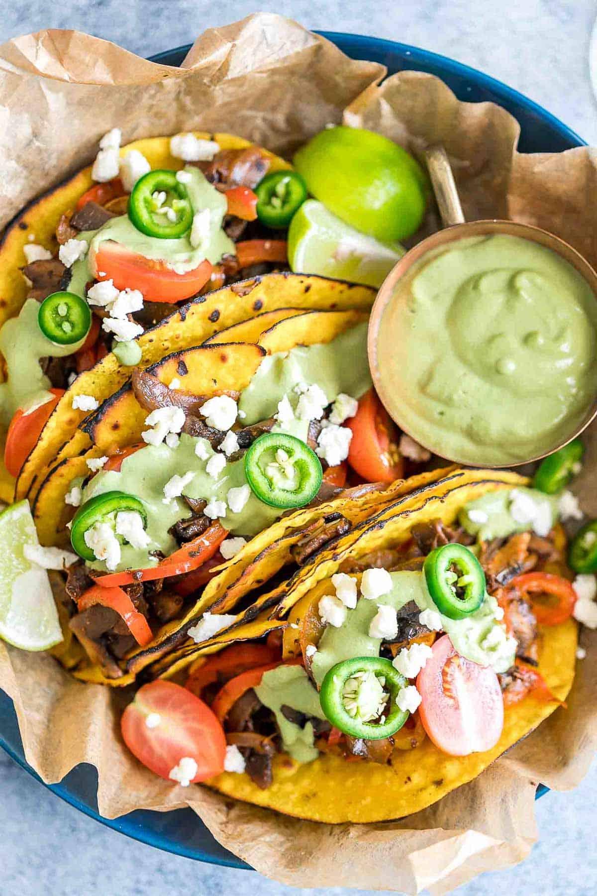 Tacos Fajita di Funghi Portobello Vegetariani 2 Tacos Fajita Vegetariani con Funghi Portobello serviti con salsa di avocado e coriandolo a lato.