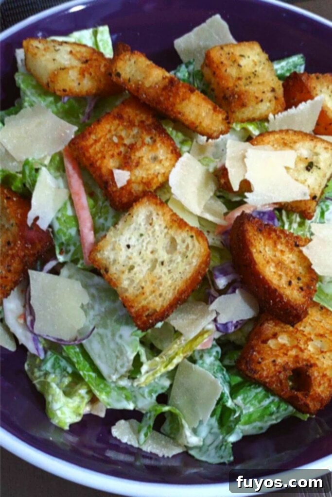Crispy Herb Garlic Croutons Made in Your Air Fryer 9 garlic and herb air fryer croutons on top of a salad