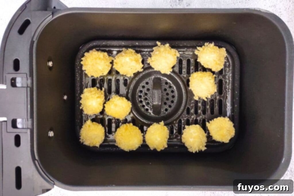 Air Fryer Goat Cheese Balls Crunchy Creamy Delight 11 Spraying the tops of the breaded goat cheese balls with olive oil before air frying.