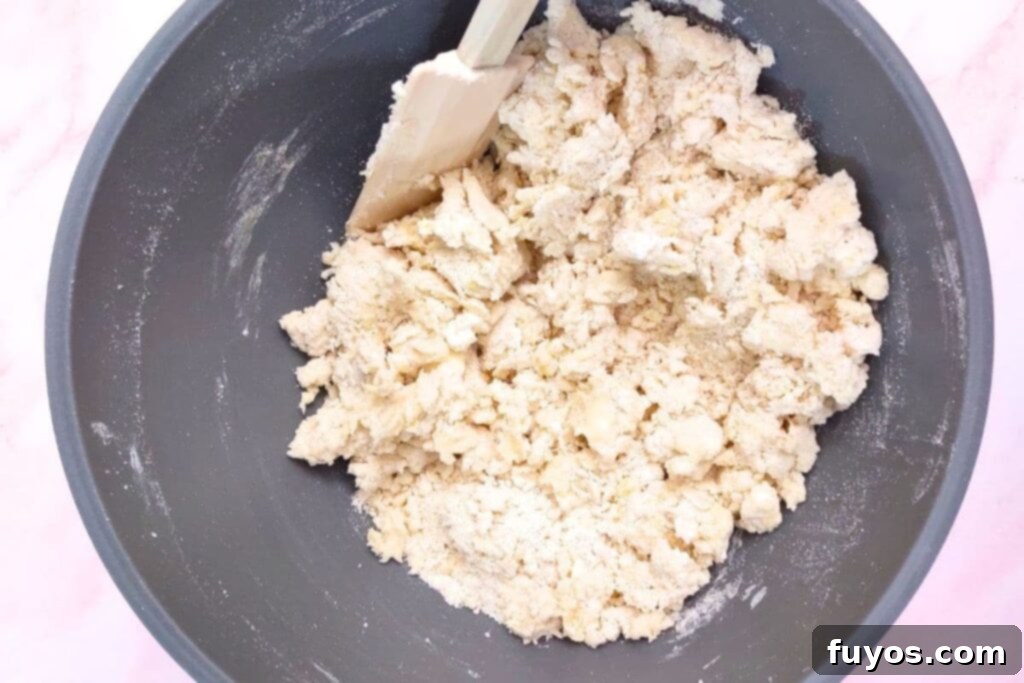Adding egg and sour cream to the crumbly scone mixture