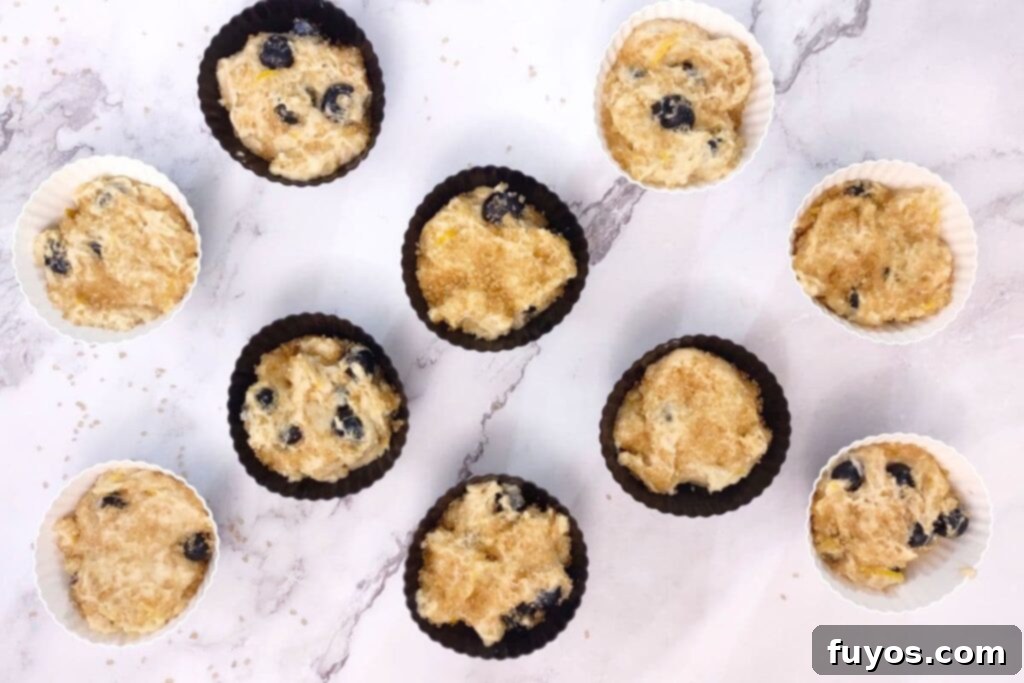 Air Fryer Blueberry Muffins Bite Into Bliss 8 fill silicone wrappers with blueberry muffin batter